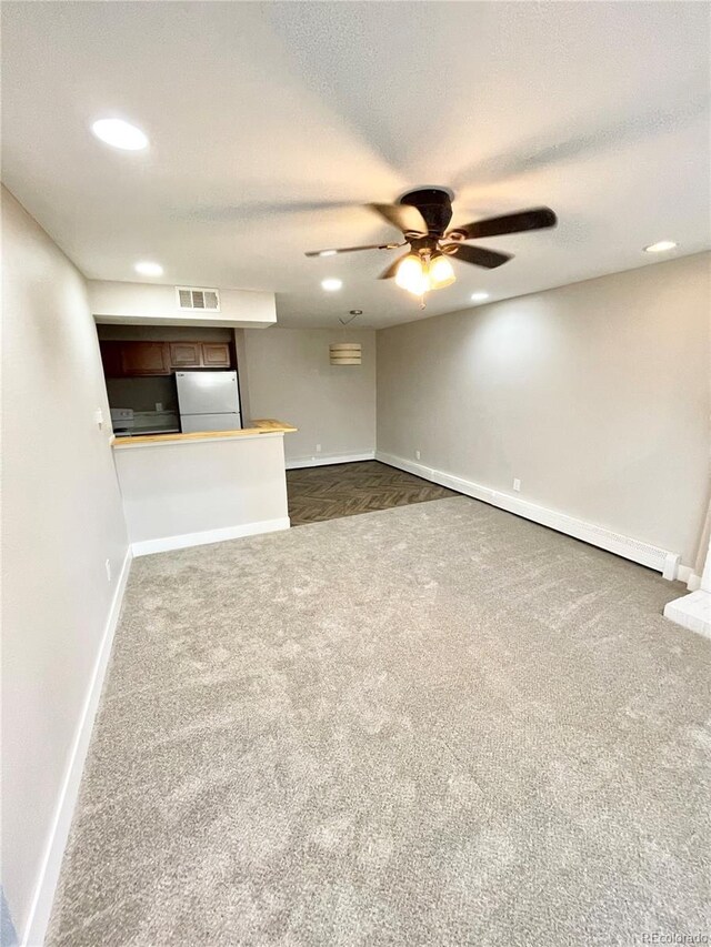 64 Nome Way Unit C, Aurora, CO 80012 - unfurnished living room with dark colored carpet, ceiling fan, baseboards, recessed lighting, and a textured ceiling