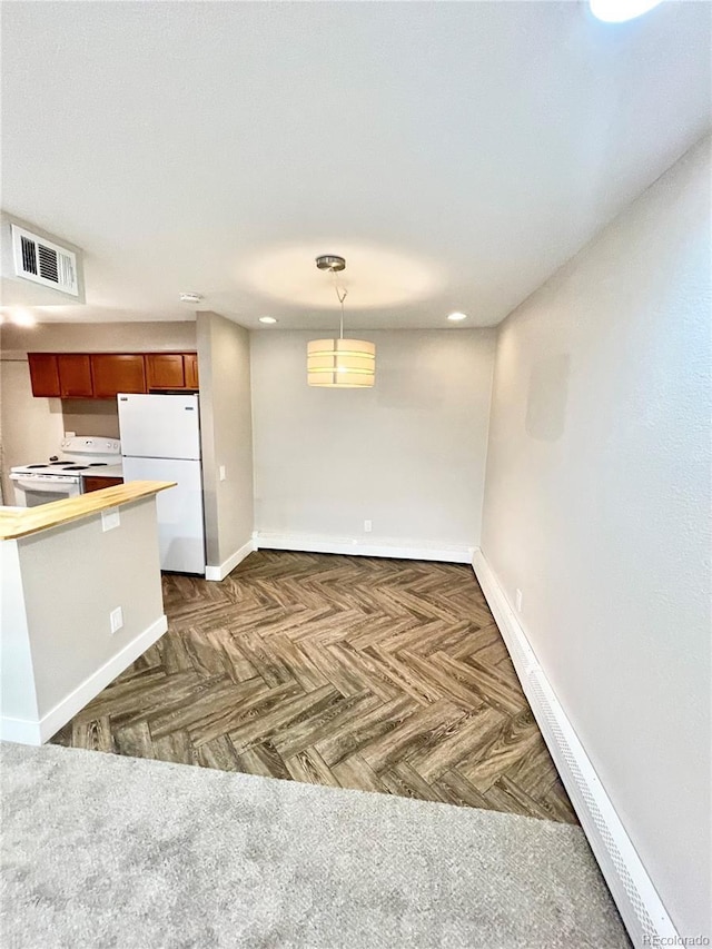 64 Nome Way Unit C, Aurora, CO 80012 - kitchen with white appliances, baseboards, decorative light fixtures, recessed lighting, and brown cabinetry