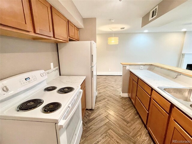 64 Nome Way Unit C, Aurora, CO 80012 - kitchen featuring electric range, brown cabinetry, light countertops, pendant lighting, and baseboards