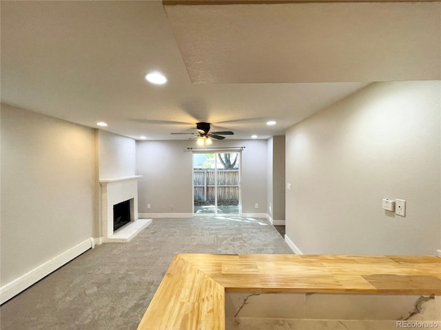 64 Nome Way Unit C, Aurora, CO 80012 - unfurnished living room with carpet floors, a ceiling fan, recessed lighting, a fireplace with raised hearth, and baseboards