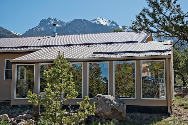 view of side of home with a mountain view