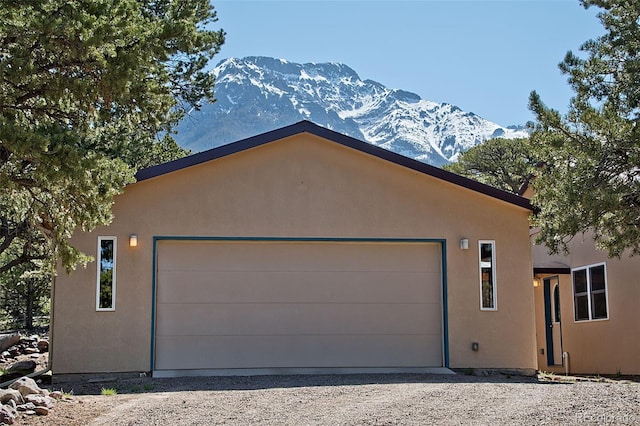 view of front of house featuring a mountain view and a garage