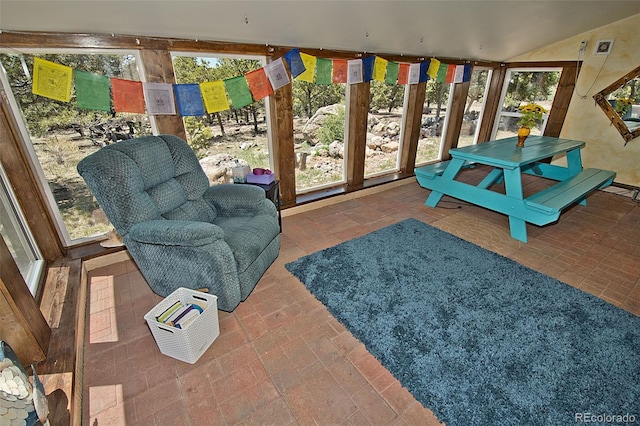 sunroom / solarium with lofted ceiling and a wealth of natural light