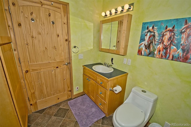 bathroom featuring vanity and toilet