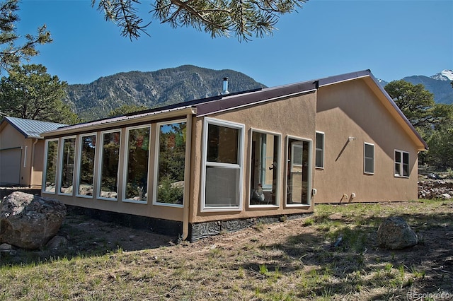 view of home's exterior with a mountain view