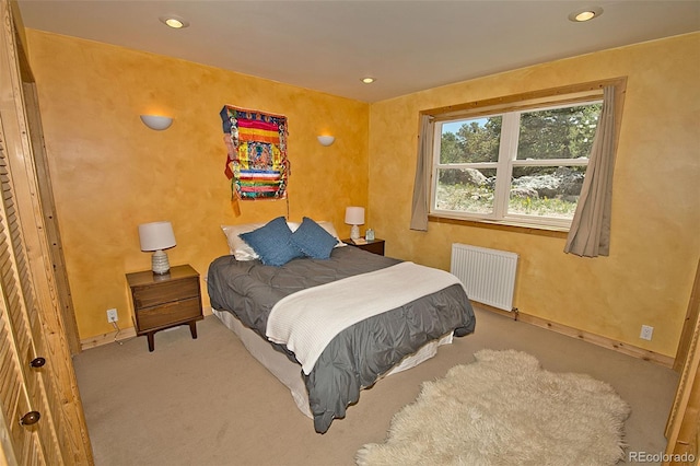 carpeted bedroom with radiator