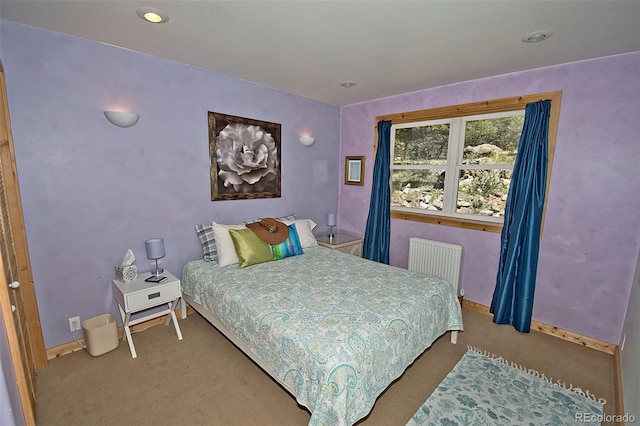 bedroom with radiator and carpet flooring