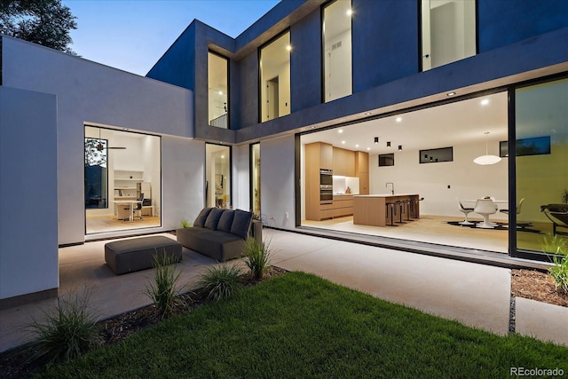 back of house featuring stucco siding