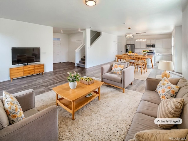 living area with light wood-style floors and stairway