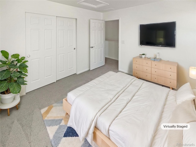 bedroom with attic access, a closet, carpet floors, and baseboards