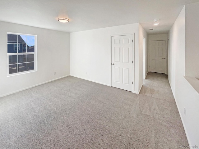 carpeted spare room with baseboards