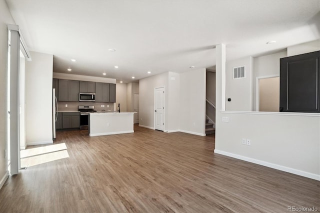 14135 Deertrack Ln, Parker, CO 80134 - unfurnished living room with recessed lighting, wood finished floors, baseboards, and stairs