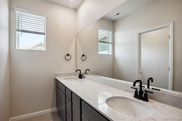 14135 Deertrack Ln, Parker, CO 80134 - bathroom featuring double vanity and baseboards