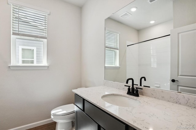 14135 Deertrack Ln, Parker, CO 80134 - bathroom with toilet, vanity, a shower, baseboards, and wood finished floors