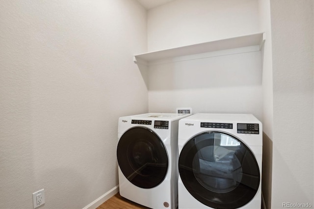 14135 Deertrack Ln, Parker, CO 80134 - laundry room featuring washing machine and dryer, baseboards, and light wood-type flooring