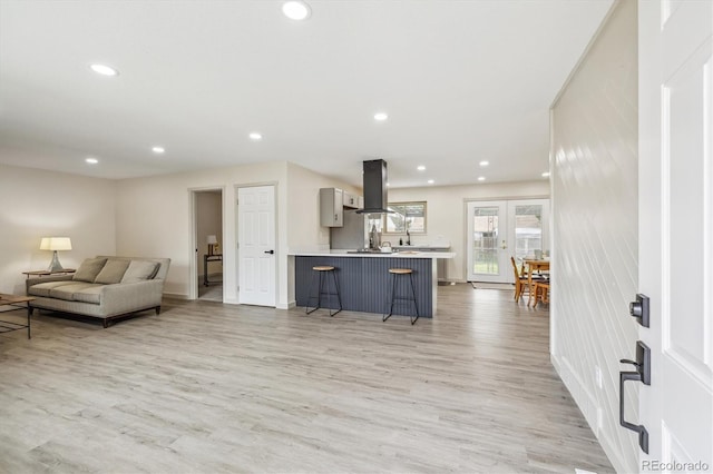 7952 Zuni St, Denver, CO 80221 - living area featuring light wood finished floors, recessed lighting, and baseboards