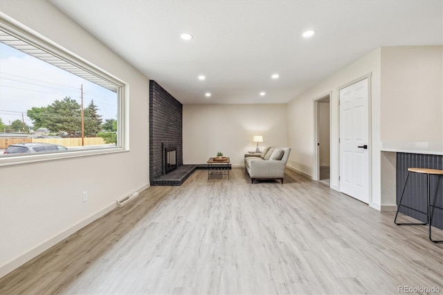 7952 Zuni St, Denver, CO 80221 - sitting room featuring recessed lighting, wood finished floors, baseboards, and a fireplace