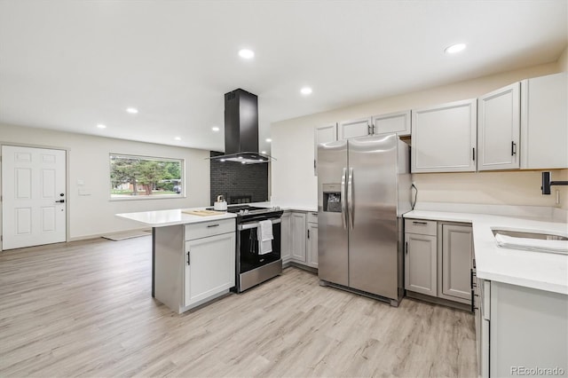 7952 Zuni St, Denver, CO 80221 - kitchen with appliances with stainless steel finishes, island exhaust hood, a peninsula, a sink, and light wood-style floors
