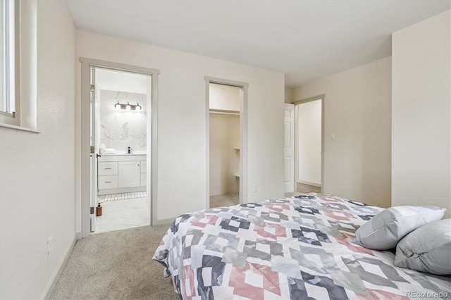 7952 Zuni St, Denver, CO 80221 - carpeted bedroom with ensuite bath, a spacious closet, and baseboards