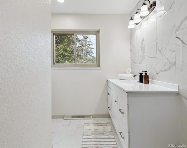 7952 Zuni St, Denver, CO 80221 - bathroom featuring vanity, marble finish flooring, and baseboards