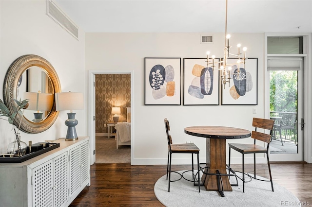 dining room featuring dark hardwood / wood-style flooring and a chandelier