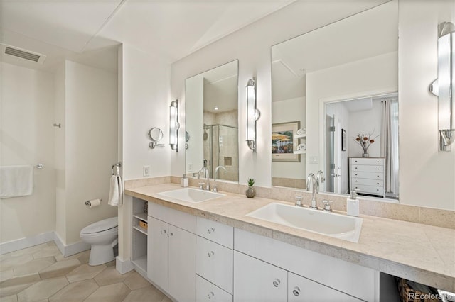 bathroom featuring vanity, a shower with shower door, tile patterned floors, and toilet