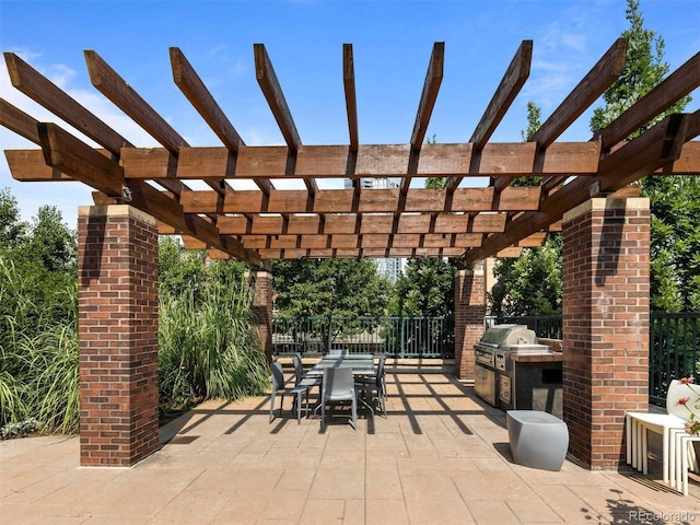 view of patio with a pergola, grilling area, and an outdoor kitchen