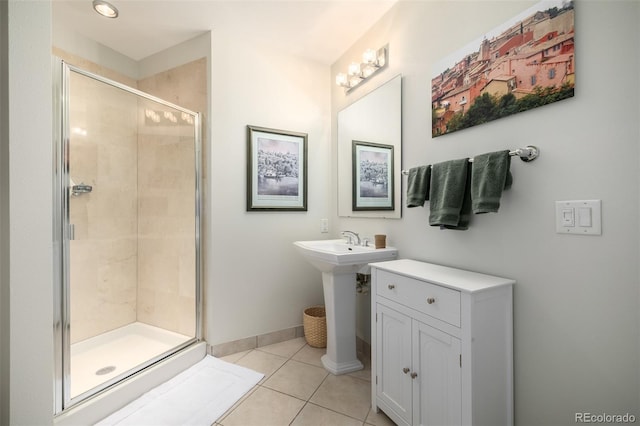 full bathroom with a shower stall, baseboards, and tile patterned floors