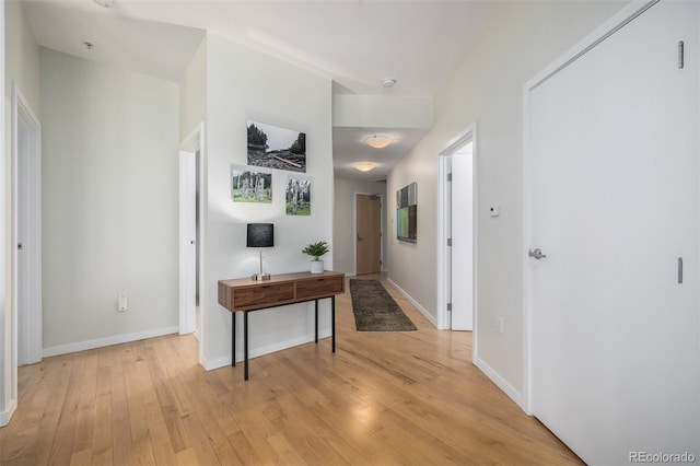 corridor with light hardwood / wood-style floors