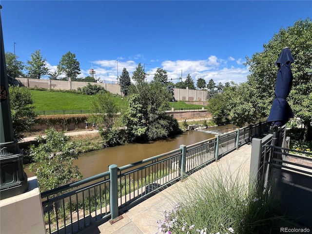 exterior space featuring a water view and fence