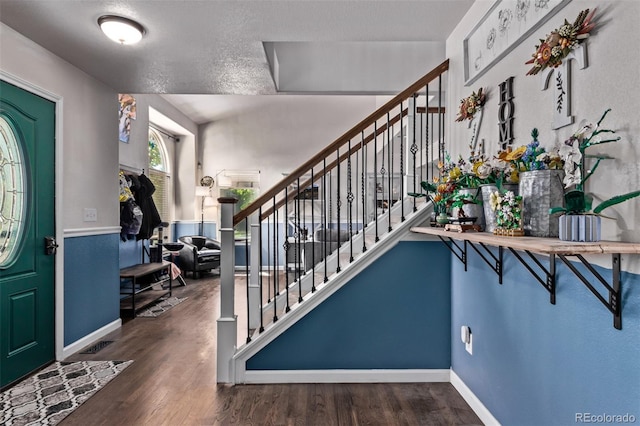105 Hawthorn St, Frederick, CO 80530 - foyer featuring wood finished floors, stairway, baseboards, and a textured ceiling