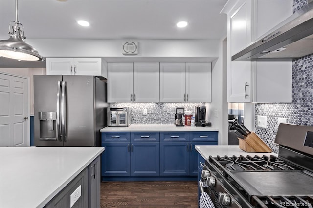 105 Hawthorn St, Frederick, CO 80530 - kitchen with appliances with stainless steel finishes, under cabinet range hood, blue cabinetry, decorative backsplash, and white cabinets