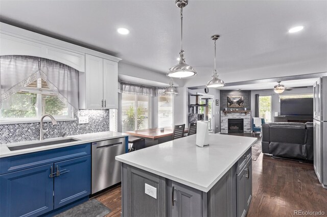 105 Hawthorn St, Frederick, CO 80530 - kitchen featuring stainless steel dishwasher, a sink, blue cabinetry, light countertops, and recessed lighting