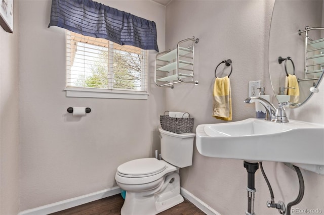 105 Hawthorn St, Frederick, CO 80530 - bathroom featuring toilet, wood finished floors, and baseboards