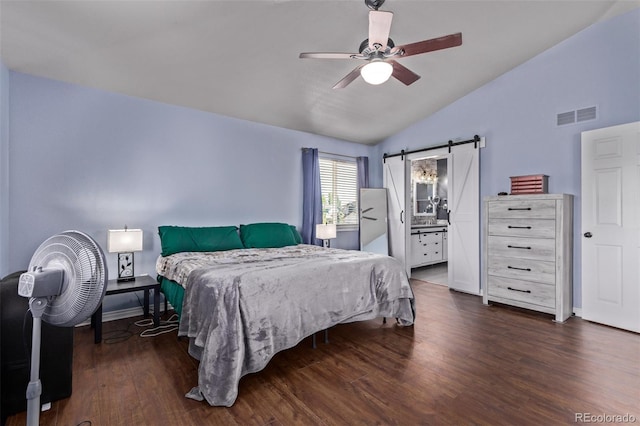 105 Hawthorn St, Frederick, CO 80530 - bedroom with vaulted ceiling, dark wood finished floors, a barn door, ceiling fan, and baseboards