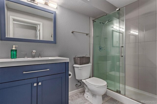 105 Hawthorn St, Frederick, CO 80530 - bathroom with toilet, vanity, a stall shower, and baseboards