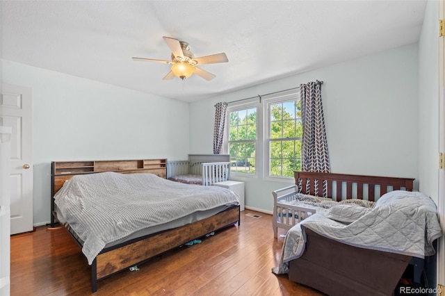 bedroom featuring ceiling fan and dark hardwood / wood-style floors