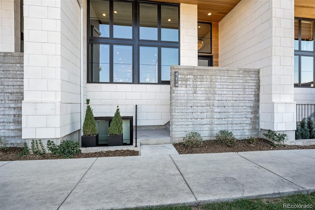 entrance to property featuring concrete block siding