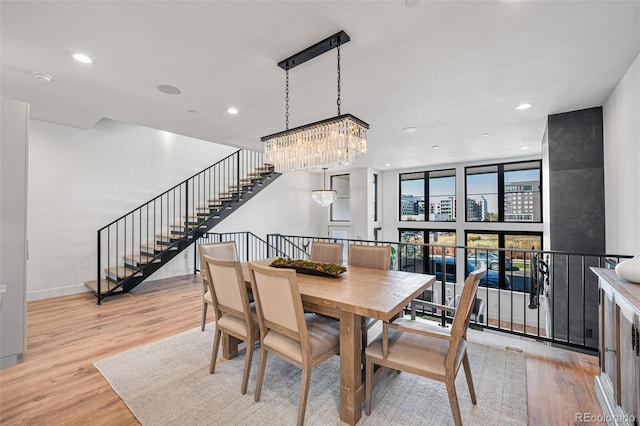 dining area with a chandelier, recessed lighting, and wood finished floors