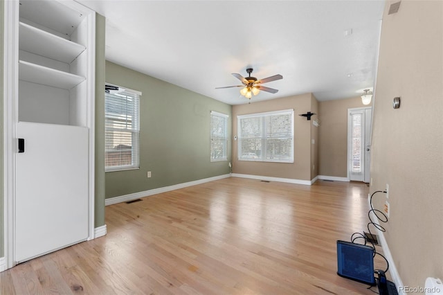 unfurnished living room featuring ceiling fan and light hardwood / wood-style floors