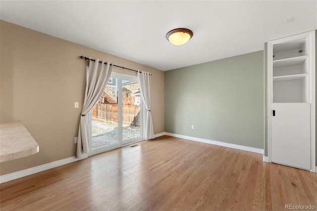 empty room with light hardwood / wood-style floors