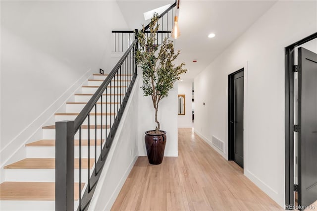 staircase with hardwood / wood-style floors