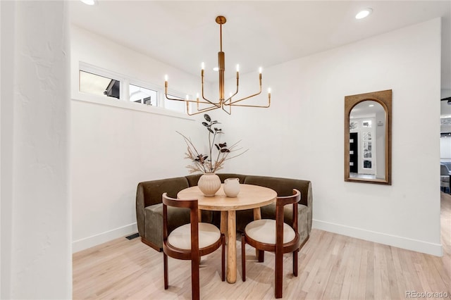 dining room featuring an inviting chandelier and light hardwood / wood-style floors