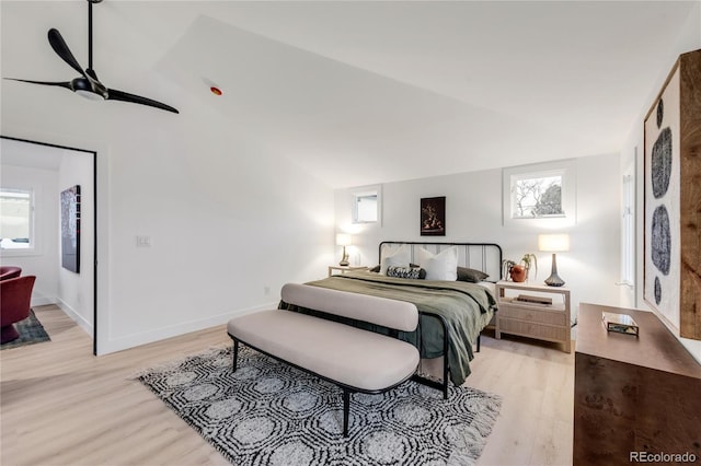 bedroom with lofted ceiling and light wood-type flooring