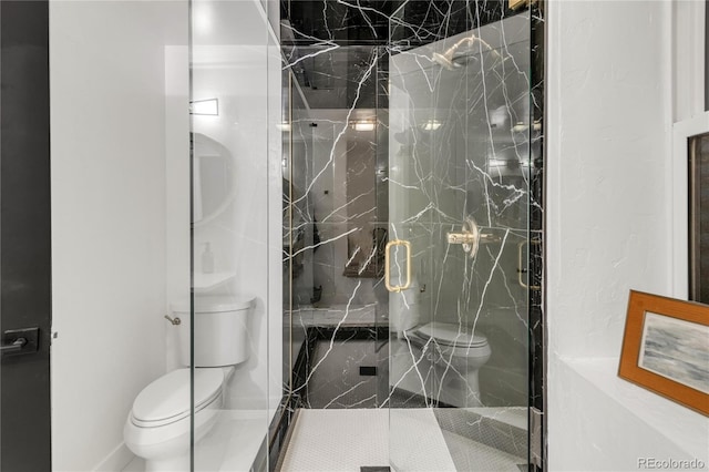 bathroom featuring an enclosed shower and toilet