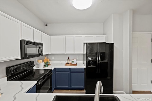 kitchen featuring blue cabinets, sink, black appliances, light hardwood / wood-style flooring, and white cabinets