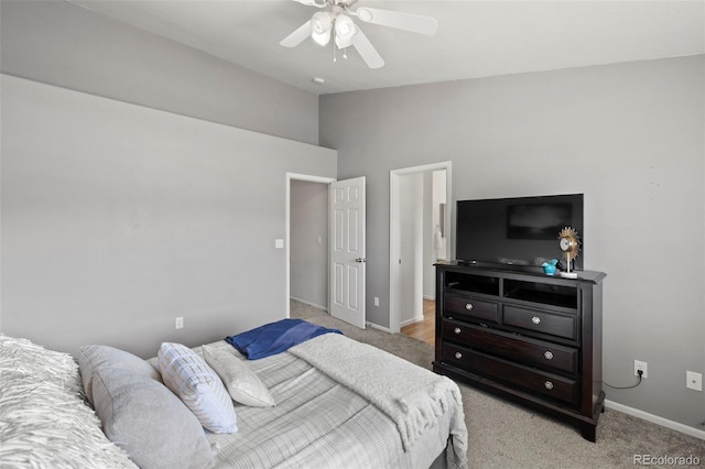 carpeted bedroom featuring ceiling fan and high vaulted ceiling