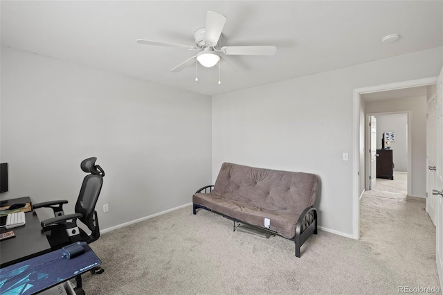 carpeted office space with ceiling fan