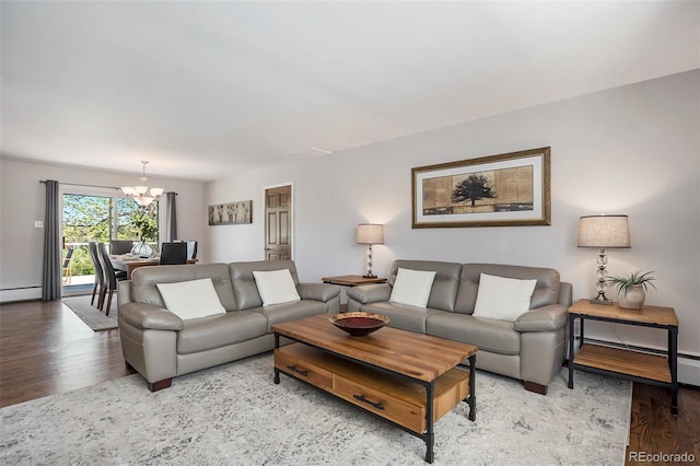 6150 S Southwood Dr, Centennial, CO 80121 - living area featuring wood finished floors, a chandelier, a baseboard heating unit, and baseboards