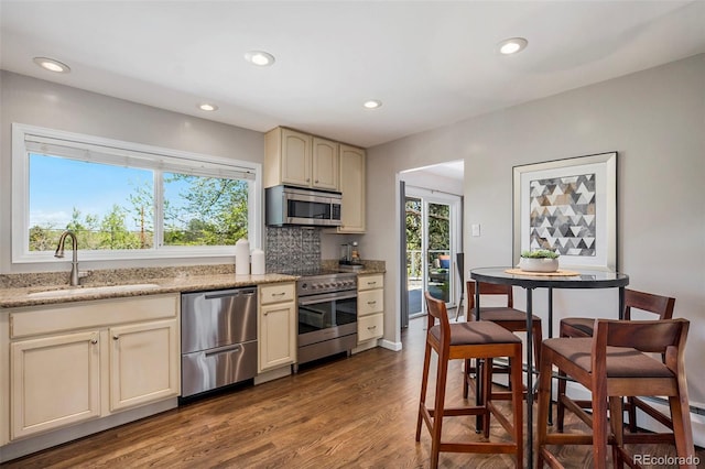 6150 S Southwood Dr, Centennial, CO 80121 - kitchen with stainless steel appliances, a sink, wood finished floors, tasteful backsplash, and recessed lighting
